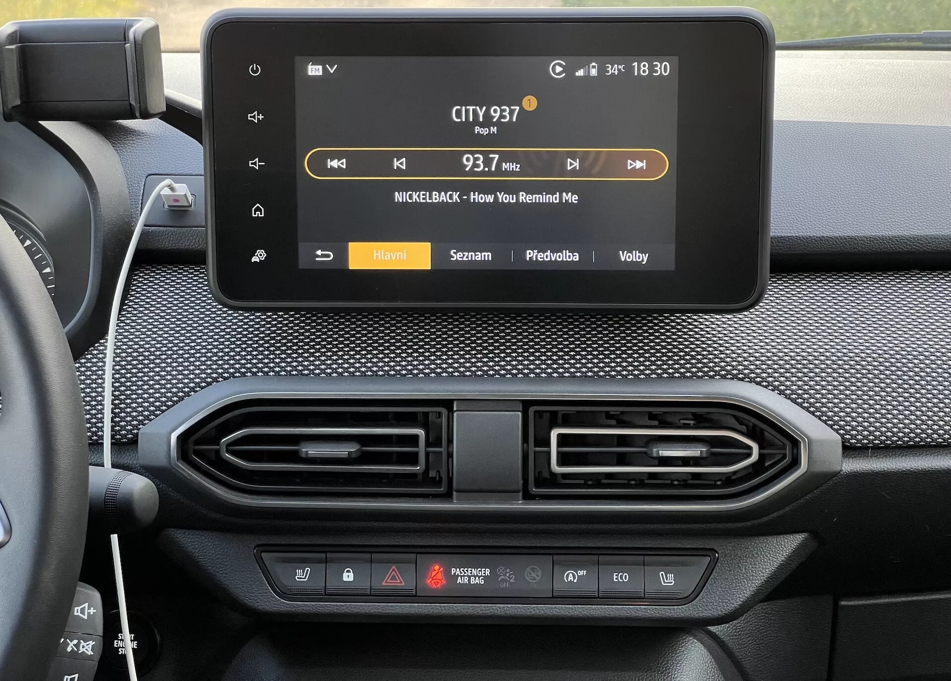 Console central Dacia Jogger 2022 com tela touchscreen de infotenimento mostrando display de rádio e saídas de ventilação do controle do clima abaixo
