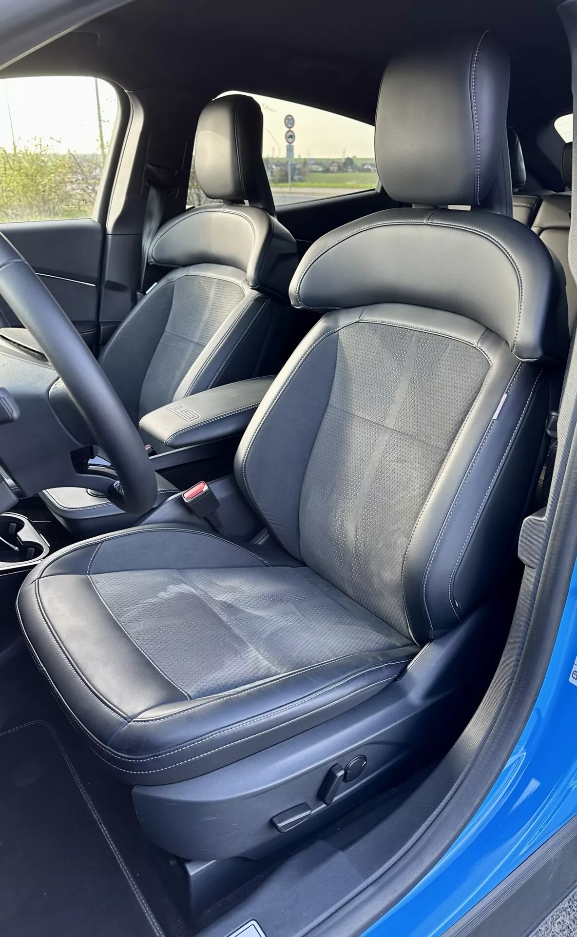 Interior do Ford Mustang Mach-E 2020 mostrando o banco do motorista com estofamento de couro e tecido, ajuste eletrônico do banco e cinto de segurança