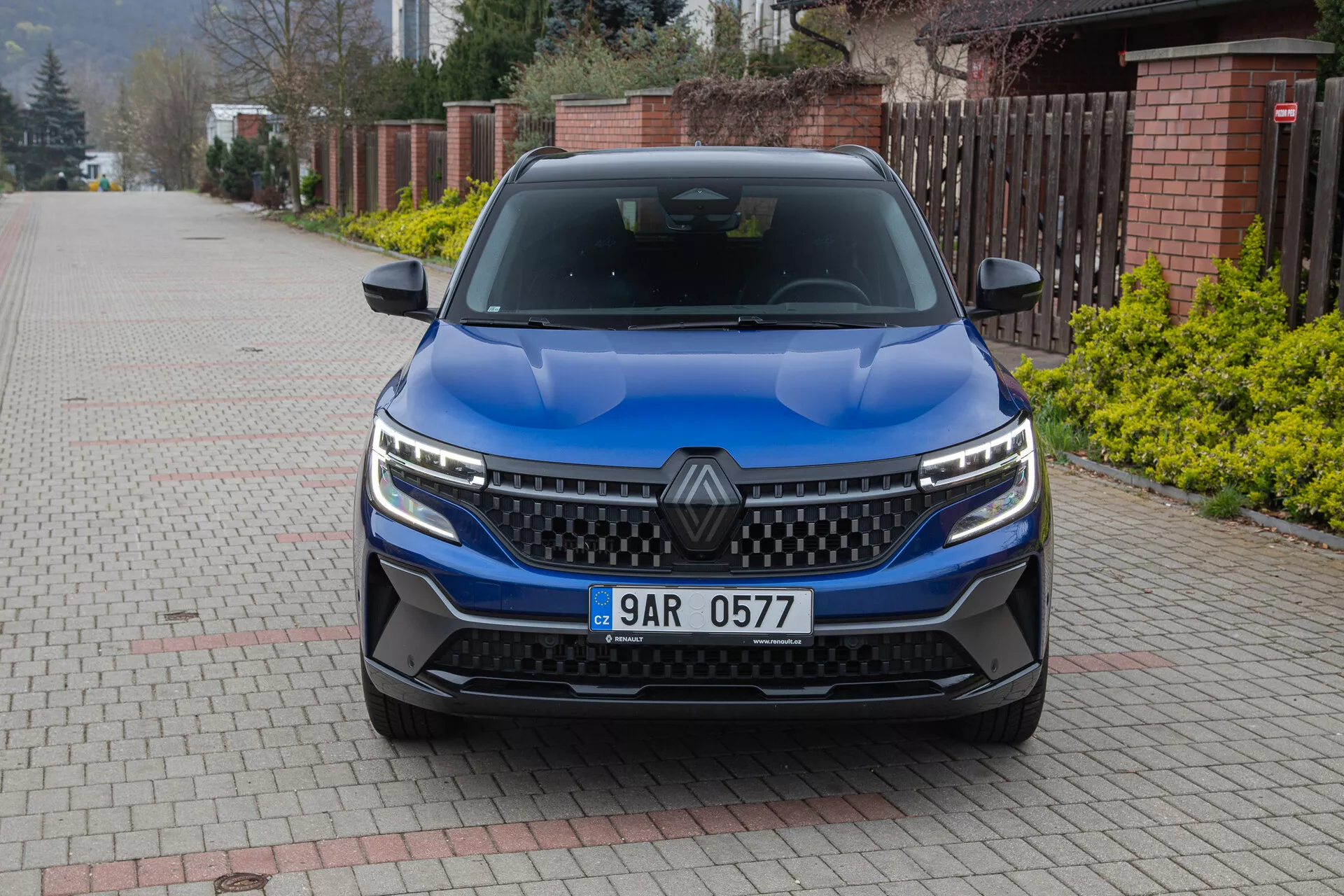 Vista frontal do Renault Austral 2022 com foco na grade, faróis de LED e design do capô com acabamento azul metálico