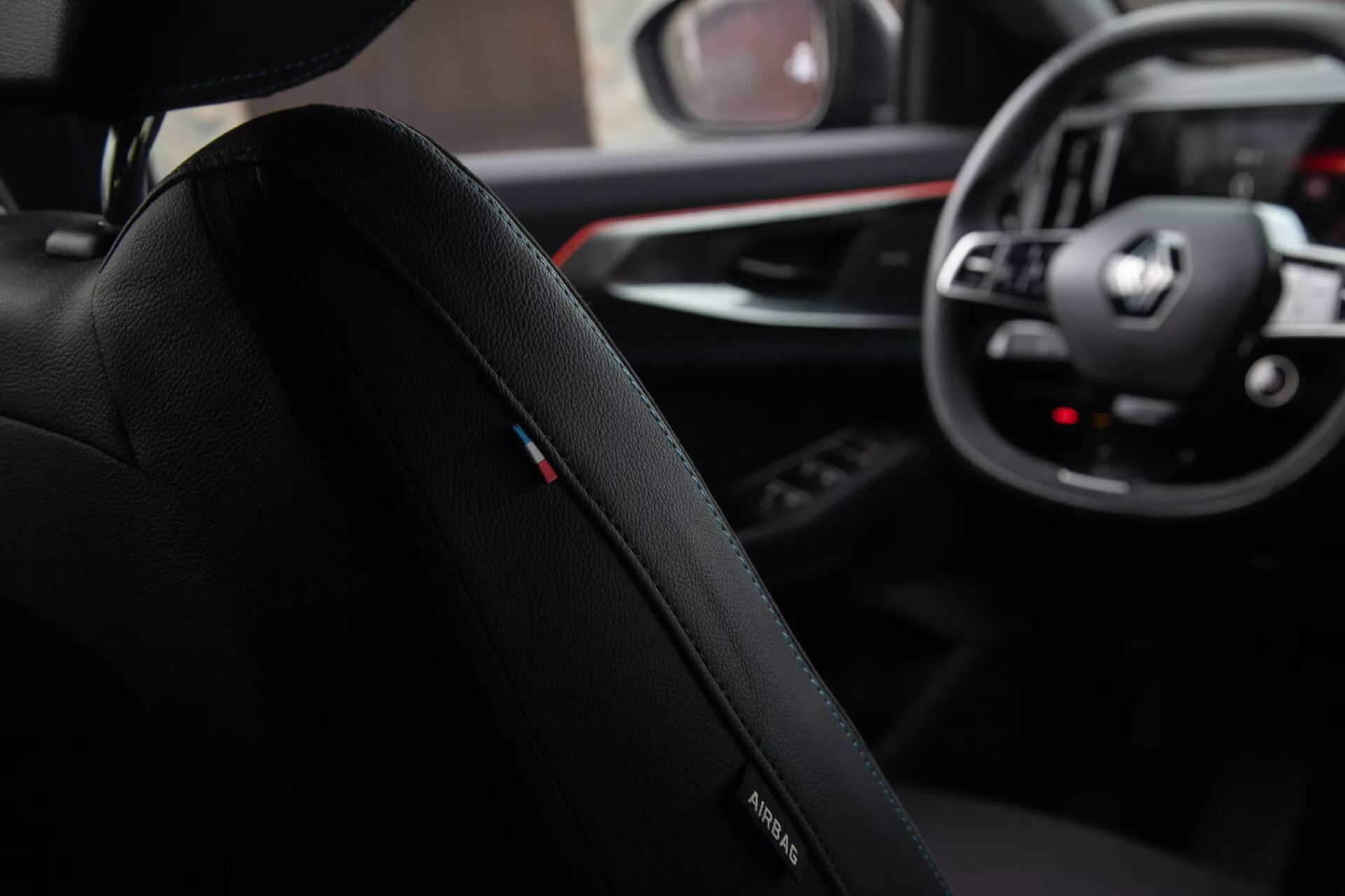 Vista interior a partir da perspectiva do passageiro traseiro apresentando o assento do condutor com logo da BMW, estofamento de couro premium e costura detalhada, focando em direção ao painel de instrumentos com emblema da BMW no volante, mostradores analógicos e displays digitais do sistema de infotainment, juntamente com um vislumbre da alavanca de câmbio e painel de controle multimídia em um design de cabine sofisticado e ergonômico.