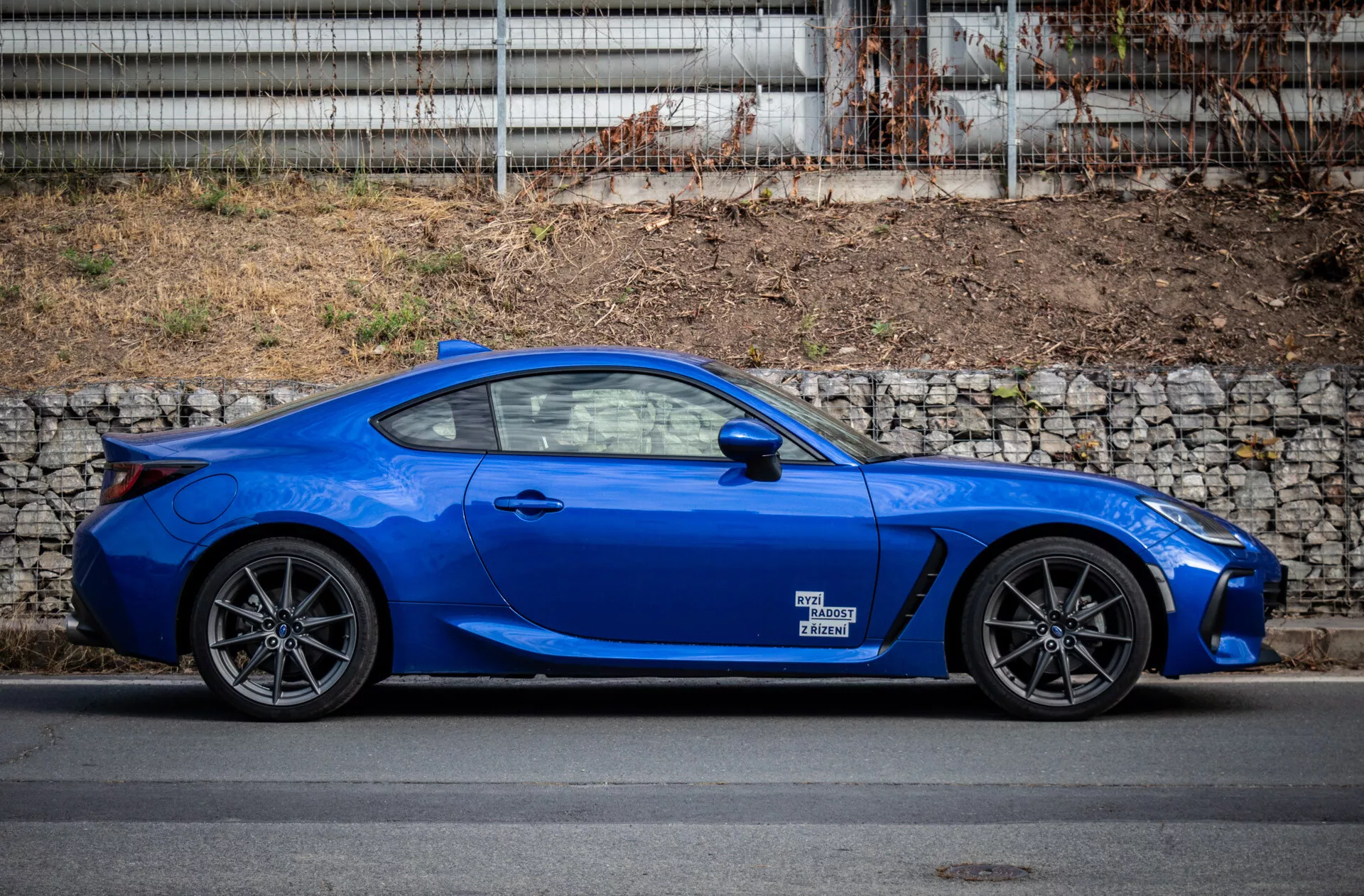 Subaru BRZ 2023 estacionado em ambiente urbano, exibindo seu design elegante e cor azul vibrante